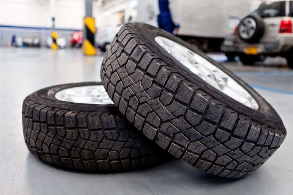 Requisition tires in a vehicle service center for automotive maintenance and repair, showcasing durable tires with detailed treads.